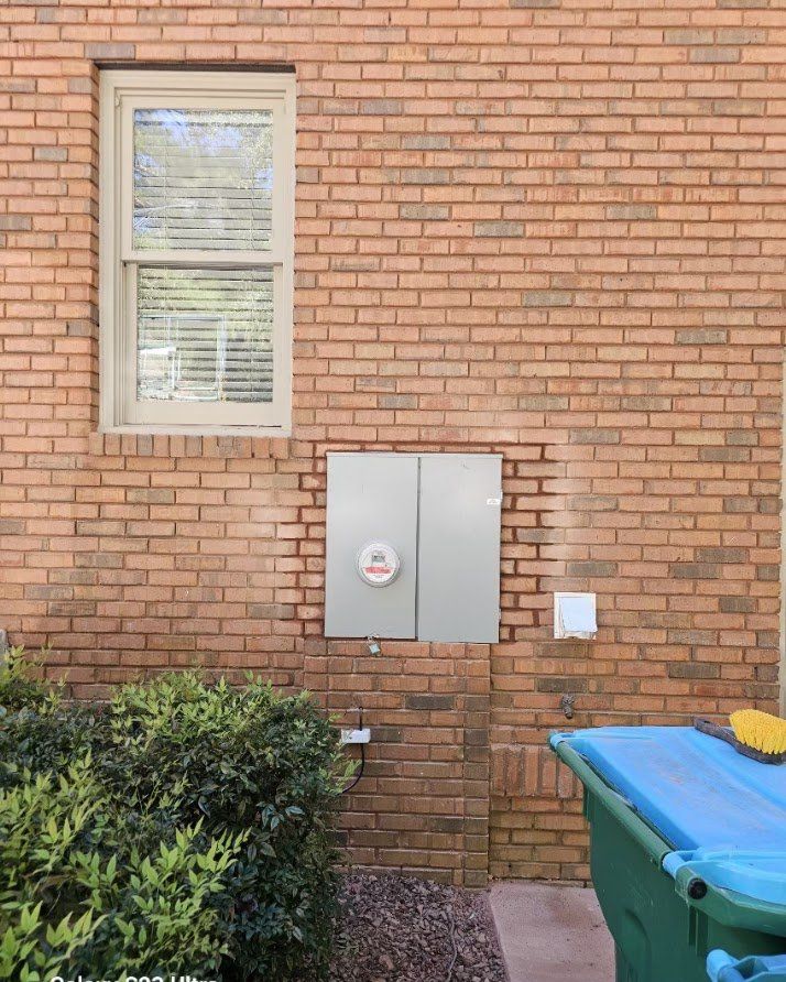 Finished 400-amp service with the brick wall repaired around it