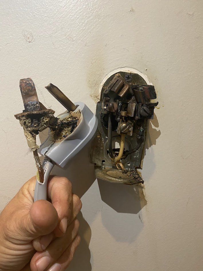 Melted dryer plug and burned dryer outlet pulled from the wall