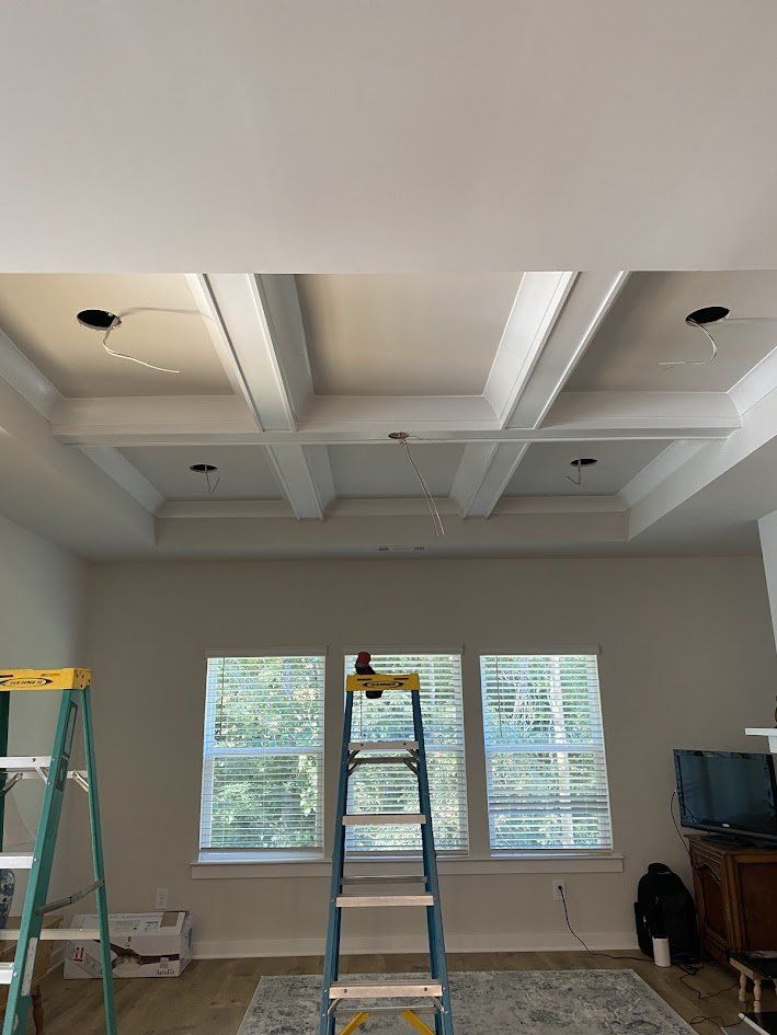 Coffered ceiling with open can-light holes and wiring before fixtures were installed