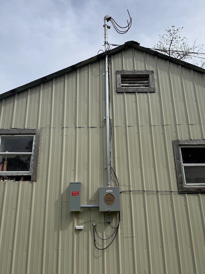 New mast, meter base and disconnect installed on the metal building